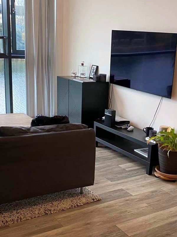 Room with sofa and TV on the wall