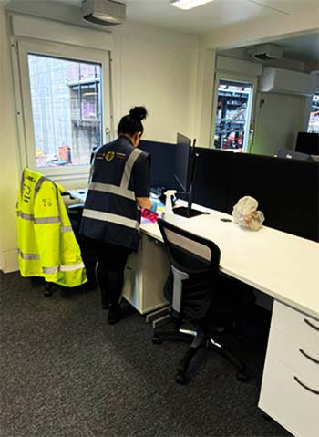 Lady cleaning office desk