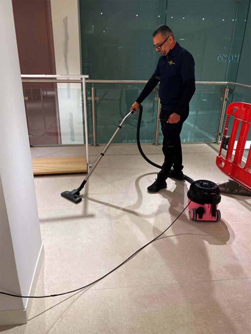 Cleaner vacuuming floor